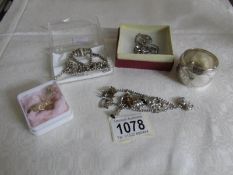 A silver charm bracelet, napkin rings, watch chain, St.