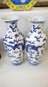 A pair of Chinese blue and white vases (restored)