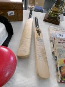 2 small signed cricket bats with multiple signatures