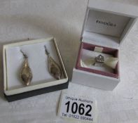 A Pandora silver charm and a pair of silver earrings