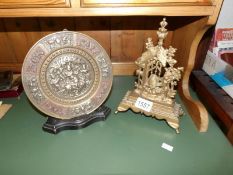 An oriental brass plaque and one other