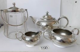 A 3 piece silver plate tea set and a glass biscuit barrel with plated top and handle