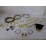 A box of vintage jewellery including ivory and silver