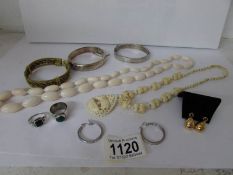 A box of vintage jewellery including ivory and silver