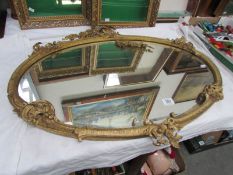 An oval bevel edged mirror in gilt frame (a/f)