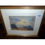 A framed and glazed mountain scene