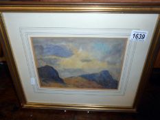 A framed and glazed mountain scene