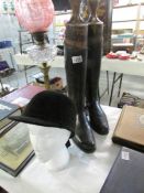 A pair of riding boots with boot trees and a Harry Hall riding hat (head not included)