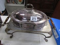 A silver plated breakfast serving dish with burner