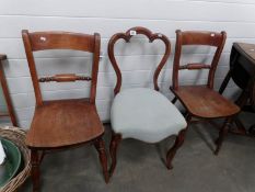 A pair of kitchen chairs and one other