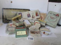 A large collection of assorted cigarette cards including sets