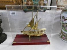 An 18ct gold plated Arabian fishing boat in display case