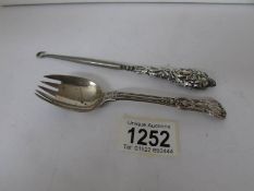 A silver cake spoon/fork and a silver handled button hook