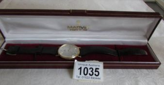 A gold Marvin Buren wrist watch in case