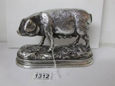 A large silver plate on resin figure of a pig,