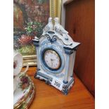 A ceramic clock surmounted doves