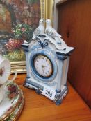 A ceramic clock surmounted doves