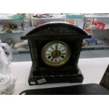 A wood cased marble effect mantel clock