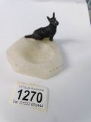 A cold painted white metal Scottie dog on an ashtray