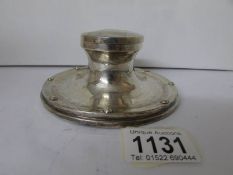 A silver inkwell hallmarked for Birmingham remaining marks rubbed,