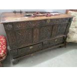 A carved oak mule chest