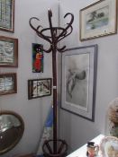 A dark wood effect bentwood hat stand