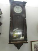 A mahogany single weight Vienna wall clock