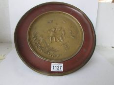 An antique embossed brass tazza