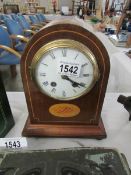 A mahogany inlaid mantel clock