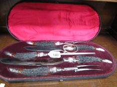 A cased 5 piece horn handled carving set