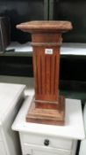 A wooden column plinth