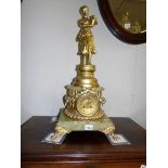 A gilt and marble clock surmounted figure