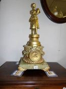 A gilt and marble clock surmounted figure