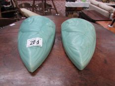 A pair of art deco pottery wall pockets