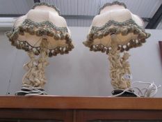 A pair of figural table lamps with shades