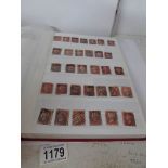 An album of stamps including approximately 180 Victorian penny reds,