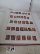An album of stamps including approximately 180 Victorian penny reds,