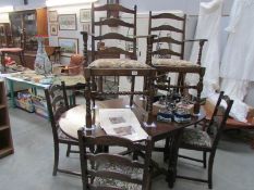 An oak gateleg table and 6 chairs