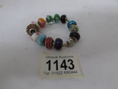 A Pandora bracelet complete with 14 silver mounted charms