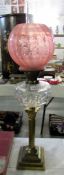 A Victorian brass corinthian column oil lamp with later shade