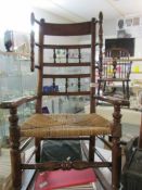 A Victorian beech rocking chair with rush seat