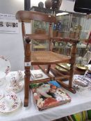 A child's rocking chair with cane seat