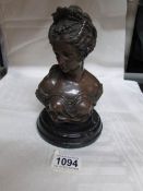 A bust of a lady mounted on black marble