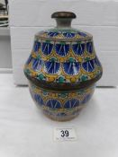 An art pottery hand painted lidded pot