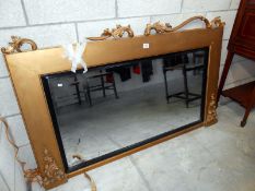 A large gilt framed overmantel mirror