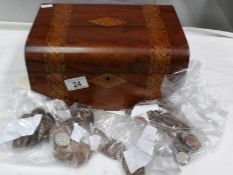 An inlaid box containing assorted coins