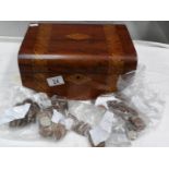 An inlaid box containing assorted coins