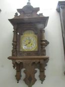 An oak wall clock with brass face