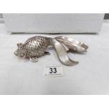 A silver plated paperweight in the shape of a fish