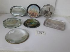 6 souvenir glass paperweights and a magnifier paper weight